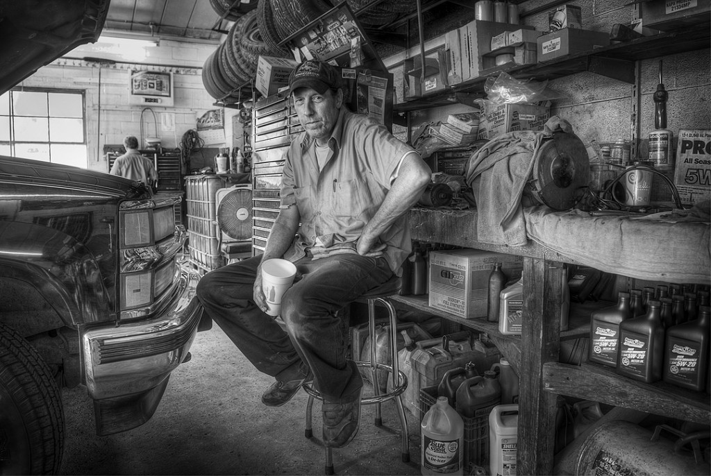 black and white photo of a car mechanic